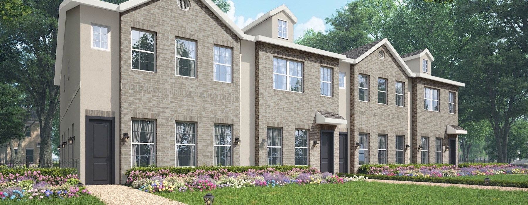 a large townhome building with a graden